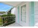 Inviting front door with decorative glass and storm door, surrounded by beautiful flowering shrubs at 24919 Drive No 1, Astor, FL 32102