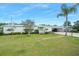 Charming single-story home with well-manicured lawn, landscaping, and attached carport at 24919 Drive No 1, Astor, FL 32102
