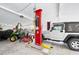 Spacious garage featuring a car lift and ample space for vehicles and equipment storage at 24919 Drive No 1, Astor, FL 32102