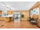 Kitchen and dining area with wood-look floors, breakfast bar, and sunroom access, creating a cozy and functional space at 24919 Drive No 1, Astor, FL 32102