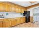 Bright kitchen with white countertops, wood cabinets, and black refrigerator at 24919 Drive No 1, Astor, FL 32102