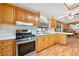 Well-lit kitchen with stainless steel appliances, wooden cabinets, and plenty of counter space for cooking and entertaining at 24919 Drive No 1, Astor, FL 32102