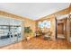 Charming living room with wood floors, complemented by bright wall art and a sliding glass door to the outdoors at 24919 Drive No 1, Astor, FL 32102