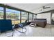 Bright sunroom featuring tile floors, large windows overlooking the backyard, and a luxurious hot tub for relaxation at 24919 Drive No 1, Astor, FL 32102