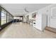 Enclosed sunroom with tile flooring, kitchenette, and a relaxing sitting area at 24919 Drive No 1, Astor, FL 32102