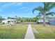 Charming house featuring a well-manicured lawn, walkway, and lovely landscaping at 24919 Drive No 1, Astor, FL 32102