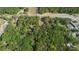 An aerial perspective of the property, displaying its dense vegetation and surrounding infrastructure at 26 E Kelly Park Rd, Apopka, FL 32712
