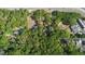 A sprawling property featuring lush tree coverage and a home near the roadway at 26 E Kelly Park Rd, Apopka, FL 32712