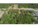 Birds-eye perspective of a residential neighborhood with dense tree coverage and a connecting roadway at 26 E Kelly Park Rd, Apopka, FL 32712
