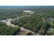 Wide aerial view showing the wooded lot's proximity to roadways, amenities, and natural surroundings at 26 E Kelly Park Rd, Apopka, FL 32712