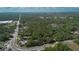 Expansive aerial view of a neighborhood with lush green trees and roadways on a partly cloudy day at 26 E Kelly Park Rd, Apopka, FL 32712