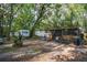 Open backyard featuring two trailer homes and a screened-in porch at 26 E Kelly Park Rd, Apopka, FL 32712