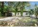 This property features a small building in the backyard surrounded by lush trees and foliage at 26 E Kelly Park Rd, Apopka, FL 32712