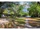 Spacious backyard with a long driveway surrounded by trees at 26 E Kelly Park Rd, Apopka, FL 32712
