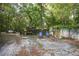 Cozy backyard featuring a storage shed, blue chairs, and fitness equipment at 26 E Kelly Park Rd, Apopka, FL 32712