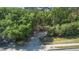View of a long driveway leading through lush greenery, offering privacy and a grand entrance at 26 E Kelly Park Rd, Apopka, FL 32712