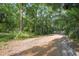 A long gravel driveway leads to a secluded home, enhancing privacy and charm at 26 E Kelly Park Rd, Apopka, FL 32712