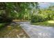Long driveway leads to a private, serene homesite surrounded by lush trees at 26 E Kelly Park Rd, Apopka, FL 32712