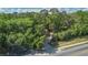 View of a long driveway leading through lush greenery, offering privacy and a grand entrance at 26 E Kelly Park Rd, Apopka, FL 32712