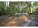 View of the home's exterior, surrounded by mature trees, offering a private and serene setting at 26 E Kelly Park Rd, Apopka, FL 32712
