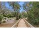 Picturesque view of an outdoor park with a walkway leading to a park area with tables and lush greenery at 26 E Kelly Park Rd, Apopka, FL 32712
