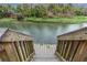 Stairs leading down to a clear river, providing easy access to swimming at 26 E Kelly Park Rd, Apopka, FL 32712