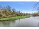 Beautiful view of the river with water lilies and lush vegetation, surrounded by trees under a clear sky at 26 E Kelly Park Rd, Apopka, FL 32712