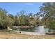 Scenic view of a natural swimming area surrounded by trees, sandy shores and landscaped features at 26 E Kelly Park Rd, Apopka, FL 32712