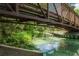 Metal bridge over clear waters and lush greenery, creating a tranquil outdoor scene with reflections at 26 E Kelly Park Rd, Apopka, FL 32712