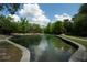 A clear canal with grassy banks and trees offers a serene outdoor environment for relaxation at 26 E Kelly Park Rd, Apopka, FL 32712