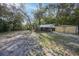 Open yard space featuring a small shack, tent covering, and metal shed at 26 E Kelly Park Rd, Apopka, FL 32712