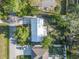 Aerial view of a property with a metal roof, landscaped yard, and long driveway at 3228 Unity Tree Dr, Edgewater, FL 32141
