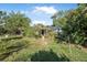 Grassy backyard with mature trees and landscaped garden, showing backyard retreat at 3228 Unity Tree Dr, Edgewater, FL 32141