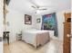 Bedroom with a queen bed, tile floors, a ceiling fan, and a window with curtains, offering comfort and style at 3228 Unity Tree Dr, Edgewater, FL 32141