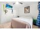 Bedroom with a queen bed, tile floors, a ceiling fan, and a window with curtains, offering comfort and style at 3228 Unity Tree Dr, Edgewater, FL 32141