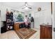 Bedroom features tile floors, desk, a ceiling fan, and ample closet space, providing a functional and comfortable environment at 3228 Unity Tree Dr, Edgewater, FL 32141