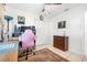 Bedroom features tile floors, desk, a ceiling fan, and ample closet space, providing a functional and comfortable environment at 3228 Unity Tree Dr, Edgewater, FL 32141