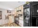 Traditional kitchen with black appliances, a light countertop, and a view into the dining area at 3228 Unity Tree Dr, Edgewater, FL 32141