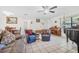 Open living room featuring tile floors, neutral walls, piano, and comfortable furniture at 3228 Unity Tree Dr, Edgewater, FL 32141
