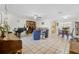 Spacious living room with tile flooring, multiple sitting areas, piano, and access to kitchen at 3228 Unity Tree Dr, Edgewater, FL 32141