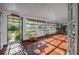 Bright sunroom featuring tile floors and multiple windows offering natural light and garden views at 3228 Unity Tree Dr, Edgewater, FL 32141