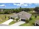 Aerial view of a beautiful house with well manicured landscaping, a long driveway, and a three car garage at 3329 Bailey Ann Dr, Ormond Beach, FL 32174