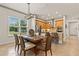 Stylish dining area adjacent to kitchen with elegant table, chairs, light fixture, and view to the backyard at 3329 Bailey Ann Dr, Ormond Beach, FL 32174
