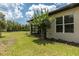 Well-maintained exterior view showcasing the home's backyard, landscaping, and charming architecture at 3329 Bailey Ann Dr, Ormond Beach, FL 32174