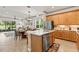 Open concept kitchen flows into dining area with stainless steel appliances and island at 3329 Bailey Ann Dr, Ormond Beach, FL 32174