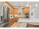 Bright kitchen featuring stainless steel appliances, an island, and warm wood cabinetry at 3329 Bailey Ann Dr, Ormond Beach, FL 32174