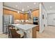 Bright kitchen featuring stainless steel appliances, an island, and warm wood cabinetry at 3329 Bailey Ann Dr, Ormond Beach, FL 32174