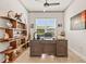 Office with built-in shelves, a large desk, ceiling fan and natural light from a window at 3329 Bailey Ann Dr, Ormond Beach, FL 32174