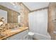 Bathroom with granite vanity countertop, tile accents, and shower with curtain at 354 Georgetown Dr, Daytona Beach, FL 32118