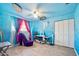 Playful bedroom with bold blue walls, unique decor, and wood-look floors at 354 Georgetown Dr, Daytona Beach, FL 32118